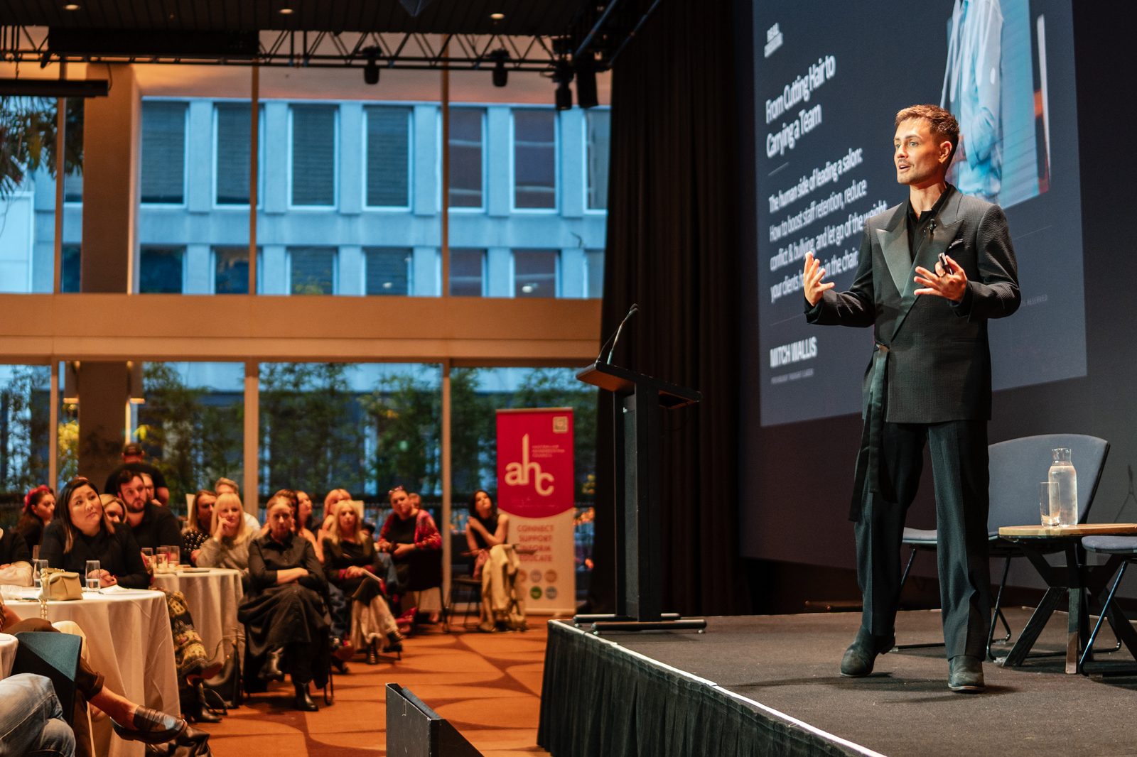 Mitch Wallis presenting on stage